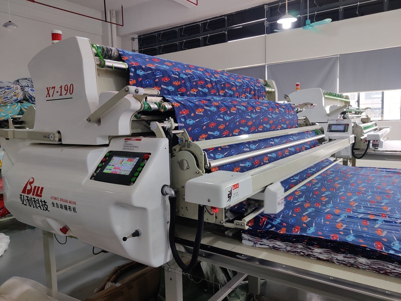 A long fabric spreading table in a factory cutting room