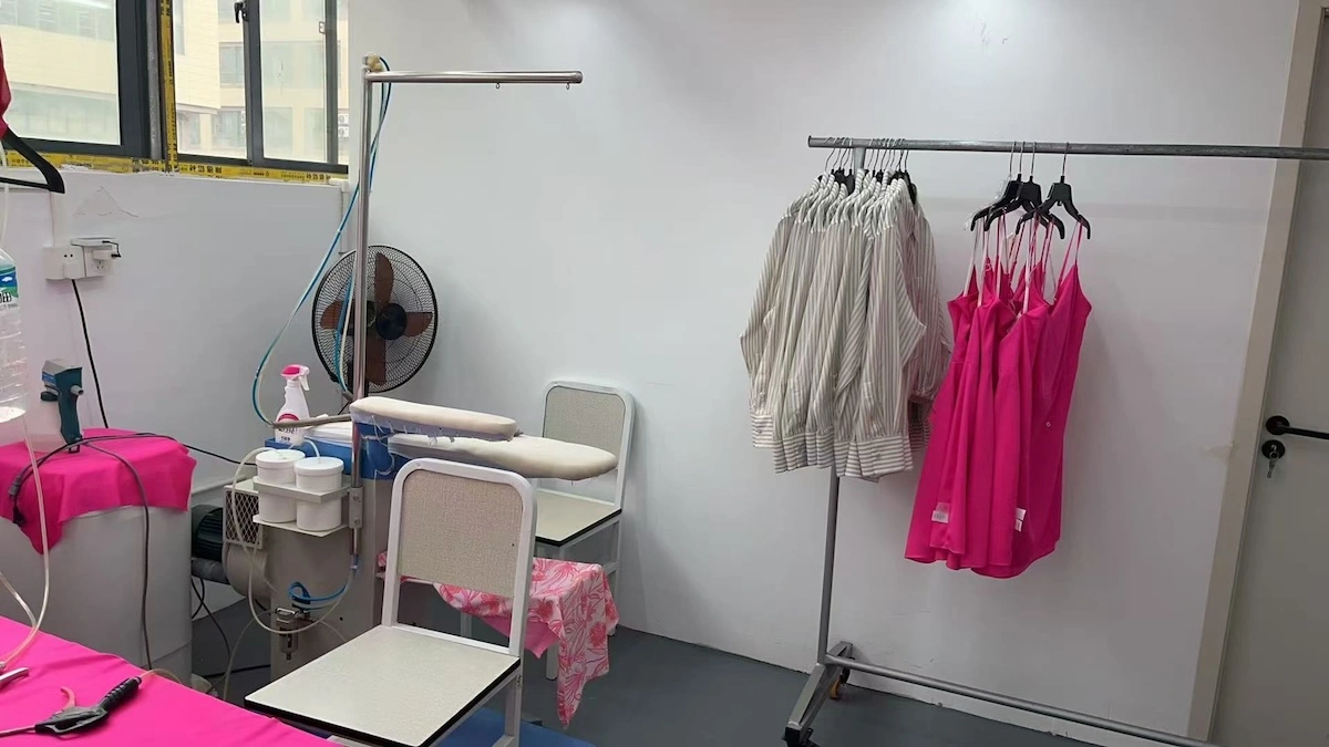 A pressing corner with a rack of finished garments A pressing corner with a rack of finished garments