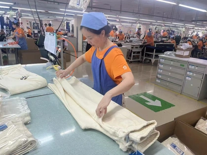 QC worker inspecting finished garments