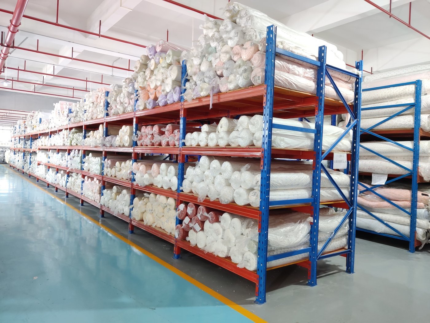Shelves of fabric bolts in a factory fabric store