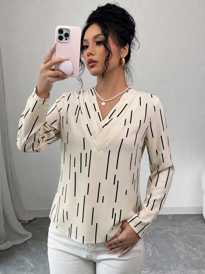 Front view of the ivory abstract-dash print v-neck long-sleeve blouse, showing the silhouette and fit.