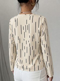 Back view of the ivory abstract-dash print v-neck long-sleeve blouse, showing the silhouette and fit.