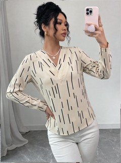 Side view of the ivory abstract-dash print v-neck long-sleeve blouse, showing the silhouette and fit.