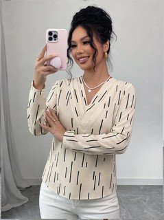 Styled front view of the ivory abstract-dash print v-neck long-sleeve blouse, showing the silhouette and fit.