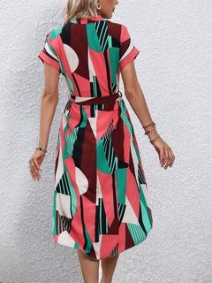 Back view of the pink and green abstract geometric shirt dress, showing its silhouette and design details.