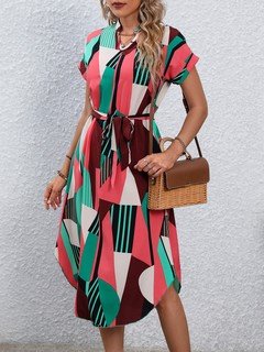 Styled front view of the pink and green abstract geometric shirt dress, showing its silhouette and design details.