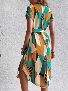 Back view of the teal and yellow abstract geometric shirt dress, showing its silhouette and design details.