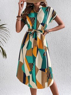 Full-length front view of the teal and yellow abstract geometric shirt dress, showing its silhouette and design details.