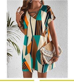 Angled front view of the teal and yellow geometric v-neck shift dress, showing its silhouette and design details.