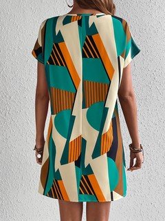Back view of the teal and yellow geometric v-neck shift dress, showing its silhouette and design details.
