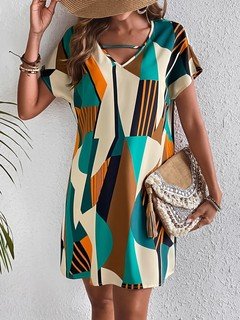 Front fit view of the teal and yellow geometric v-neck shift dress, showing its silhouette and design details.