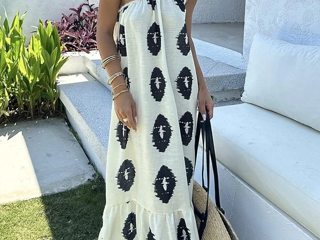 A cream and black one-shoulder shift dress photographed from the front