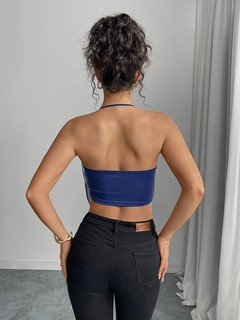 Angled back view of the blue abstract cowl-neck halter top, showing its silhouette and design details.