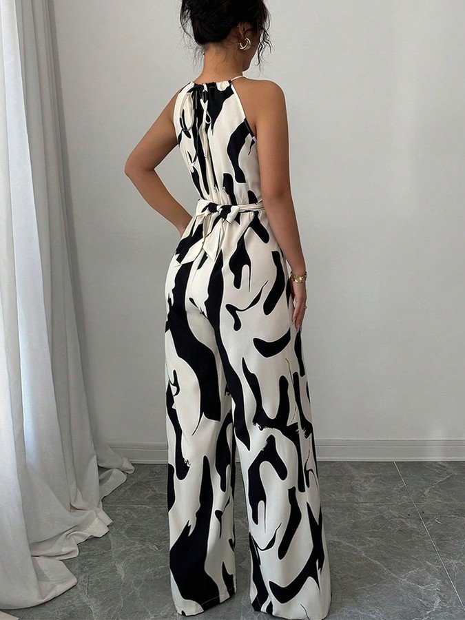 Back view of the black and white abstract halter wide-leg jumpsuit, showing its silhouette and design details.