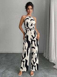 Angled front view of the black and white abstract halter wide-leg jumpsuit, showing its silhouette and design details.