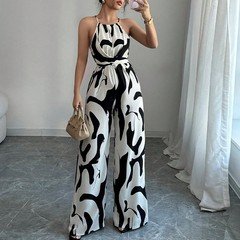 Full-length front view of the black and white abstract halter wide-leg jumpsuit, showing its silhouette and design details.