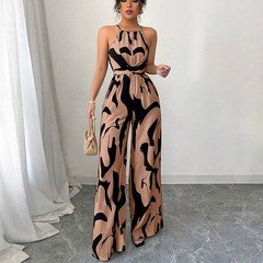 Full-length front view of the peach abstract halter wide-leg jumpsuit, showing its silhouette and design details.