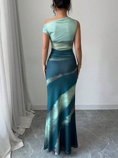 Back view of the teal and navy abstract one-shoulder maxi dress, showing its silhouette and design details.