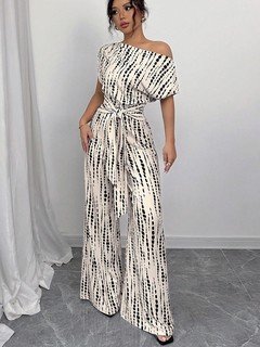 Front view of the cream and black striped one-shoulder jumpsuit, showing its silhouette and design details.