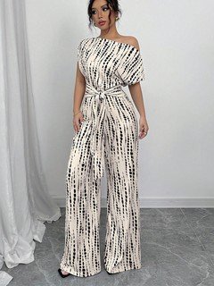 Full-length front view of the cream and black striped one-shoulder jumpsuit, showing its silhouette and design details.