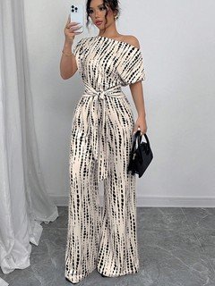 Lifestyle front view of the cream and black striped one-shoulder jumpsuit, showing its silhouette and design details.