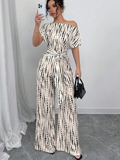 Styled front view of the cream and black striped one-shoulder jumpsuit, showing its silhouette and design details.