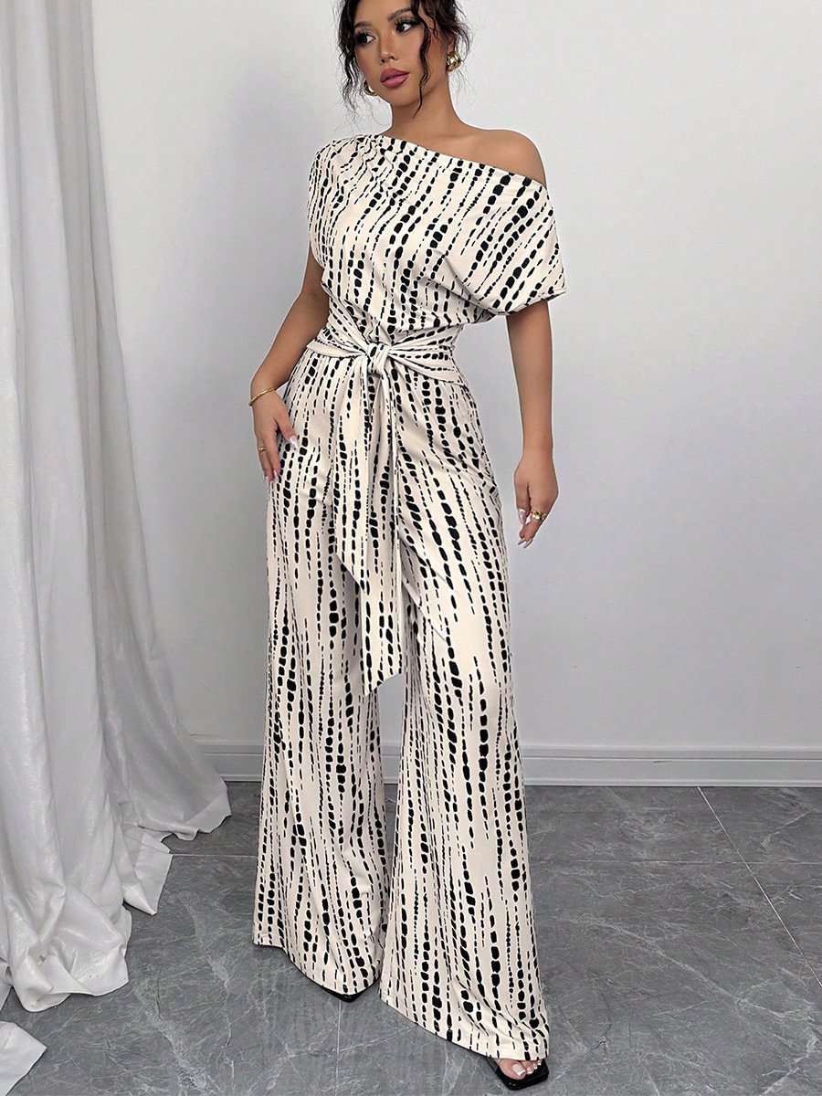 Cream And Black Striped One-Shoulder Jumpsuit – Front View Front view of the cream and black striped one-shoulder jumpsuit, showing its silhouette and design details.