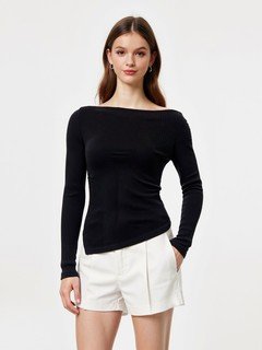 Angled front view of the black asymmetric boat-neck ruched top, showing its silhouette and design details.