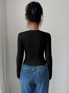 Back view of the black asymmetric draped-neck top, showing its silhouette and design details.