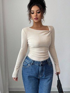 Styled front view of the ivory asymmetric draped-neck top, showing its silhouette and design details.