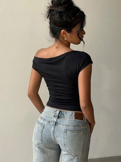Back view of the black hardware-detail off-shoulder top, showing its silhouette and design details.