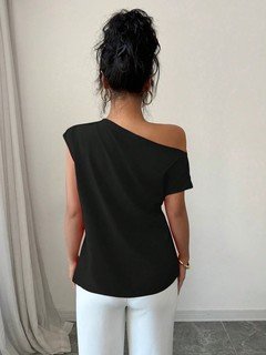 Back view of the black asymmetric one-shoulder draped sleeveless top, showing the silhouette and fit.