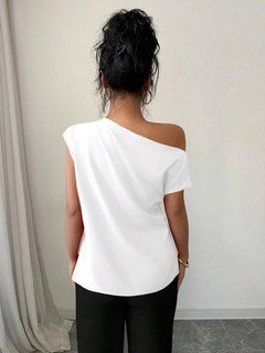 Angled front view of the white asymmetric one-shoulder draped sleeveless top, showing the silhouette and fit.