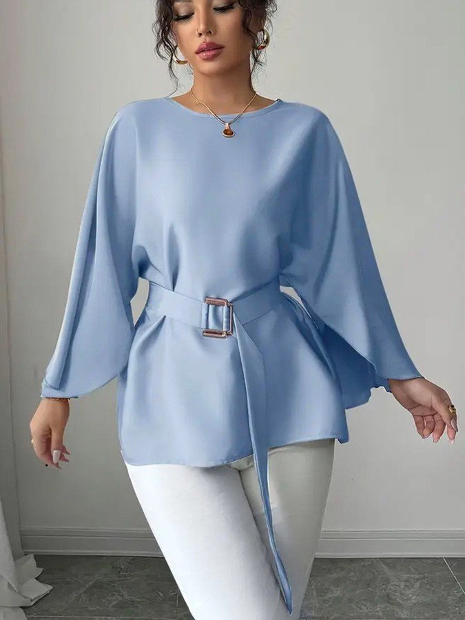 Angled front view of the light blue belted bell-sleeve blouse, showing its silhouette and design details.