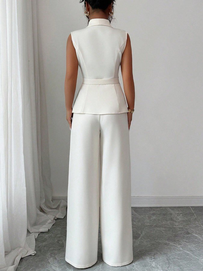 Back view of the ivory shawl-collar vest and pants set, showing its silhouette and design details.