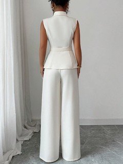 Back view of the ivory shawl-collar vest and pants set, showing its silhouette and design details.