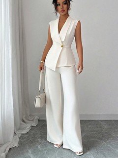 Front view of the ivory shawl-collar vest and pants set, showing its silhouette and design details.