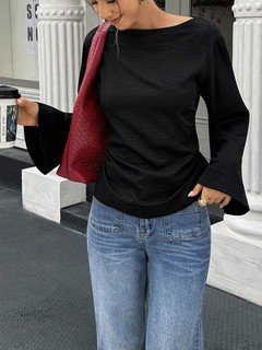 Angled front view of the black boat-neck bell-sleeve blouse, showing its silhouette and design details.