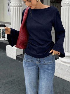 Angled front view of the navy boat-neck bell-sleeve blouse, showing its silhouette and design details.