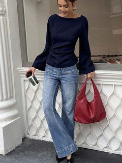 Styled front view of the navy boat-neck bell-sleeve blouse, showing its silhouette and design details.