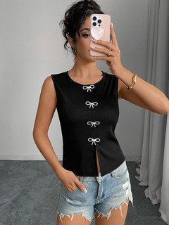 Lifestyle front view of the black bow-clasp sleeveless top, showing its silhouette and design details.
