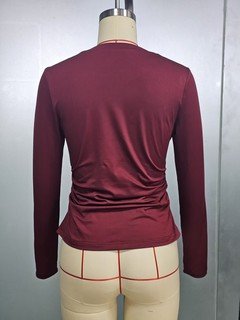 Mannequin view of the burgundy bow-motif long-sleeve ruched top, showing the garment shape and construction.
