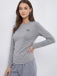 Three-quarter front view of the gray bow-motif long-sleeve ruched top, showing its silhouette and design details.