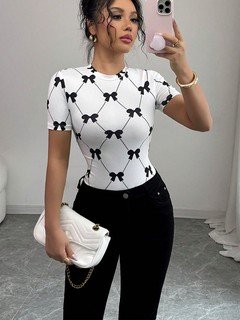 Front view of the white and black bow print short-sleeve top, showing its silhouette and design details.