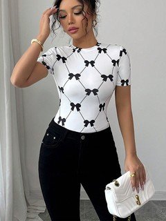 Lifestyle front view of the white and black bow print short-sleeve top, showing its silhouette and design details.