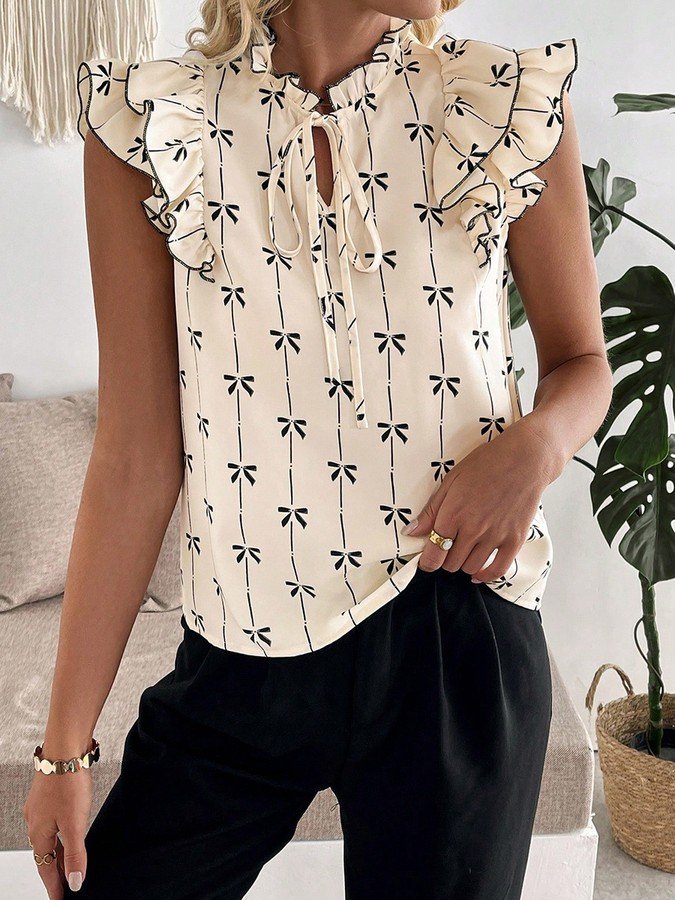 Angled front view of the cream bow print ruffle-sleeve blouse, showing its silhouette and design details.