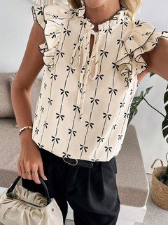 Full-length front view of the cream bow print ruffle-sleeve blouse, showing its silhouette and design details.