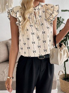 Lifestyle front view of the cream bow print ruffle-sleeve blouse, showing its silhouette and design details.