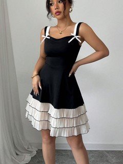 Styled front view of the black and white bow-strap tiered ruffle dress, showing its silhouette and design details.