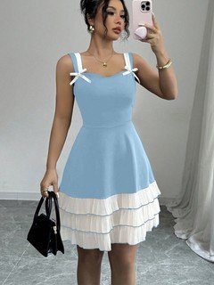 Front view of the blue and white bow-strap tiered ruffle dress, showing its silhouette and design details.